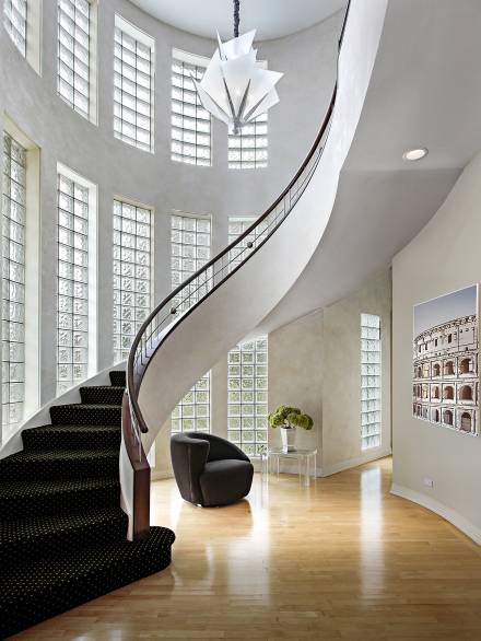 Foyer in upscale suburban home with curved staircase